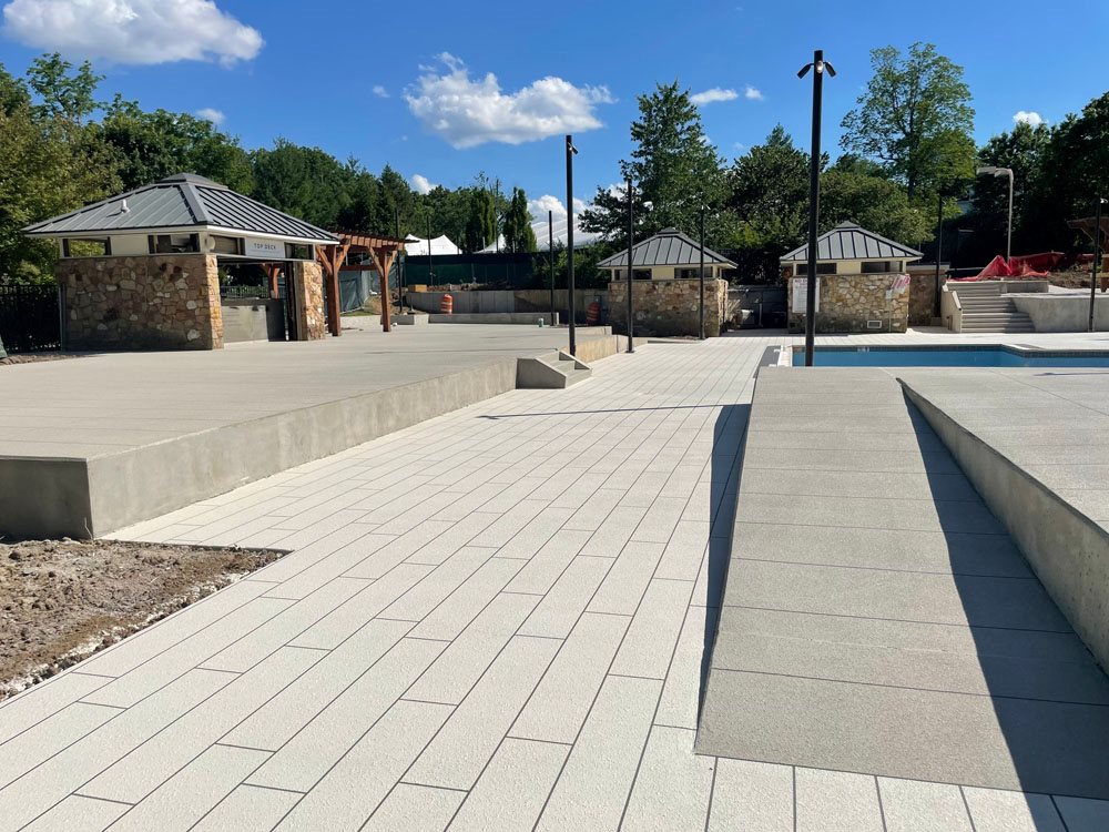 Poolside walkway installed with premium Sunsplash concrete finish